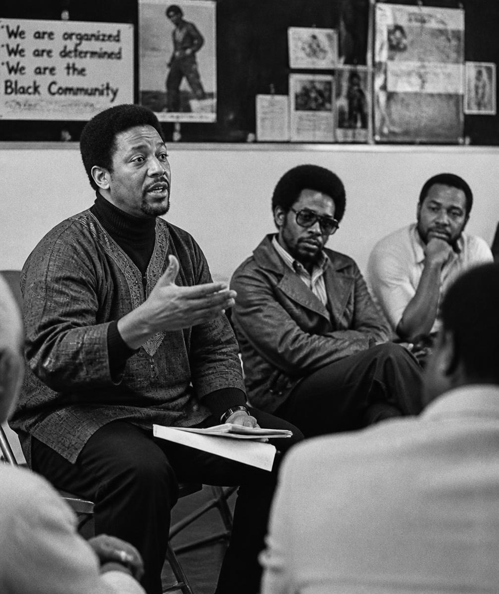 Black community leaders in conversation at a community meeting